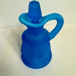 Vinatge blue satin glass decanter with stopper. Embossed with flower pattern